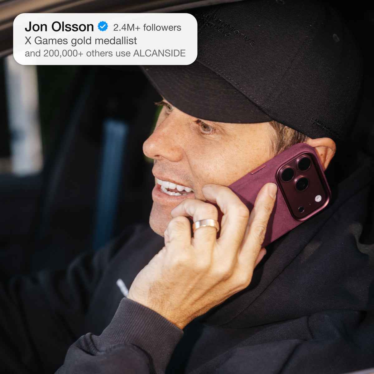 Jon Olsson with the Wine Red ALCANSIDE Alcantara case held to the ear #iPhone model:_iPhone 18 Pro|iPhone 18 Pro Max